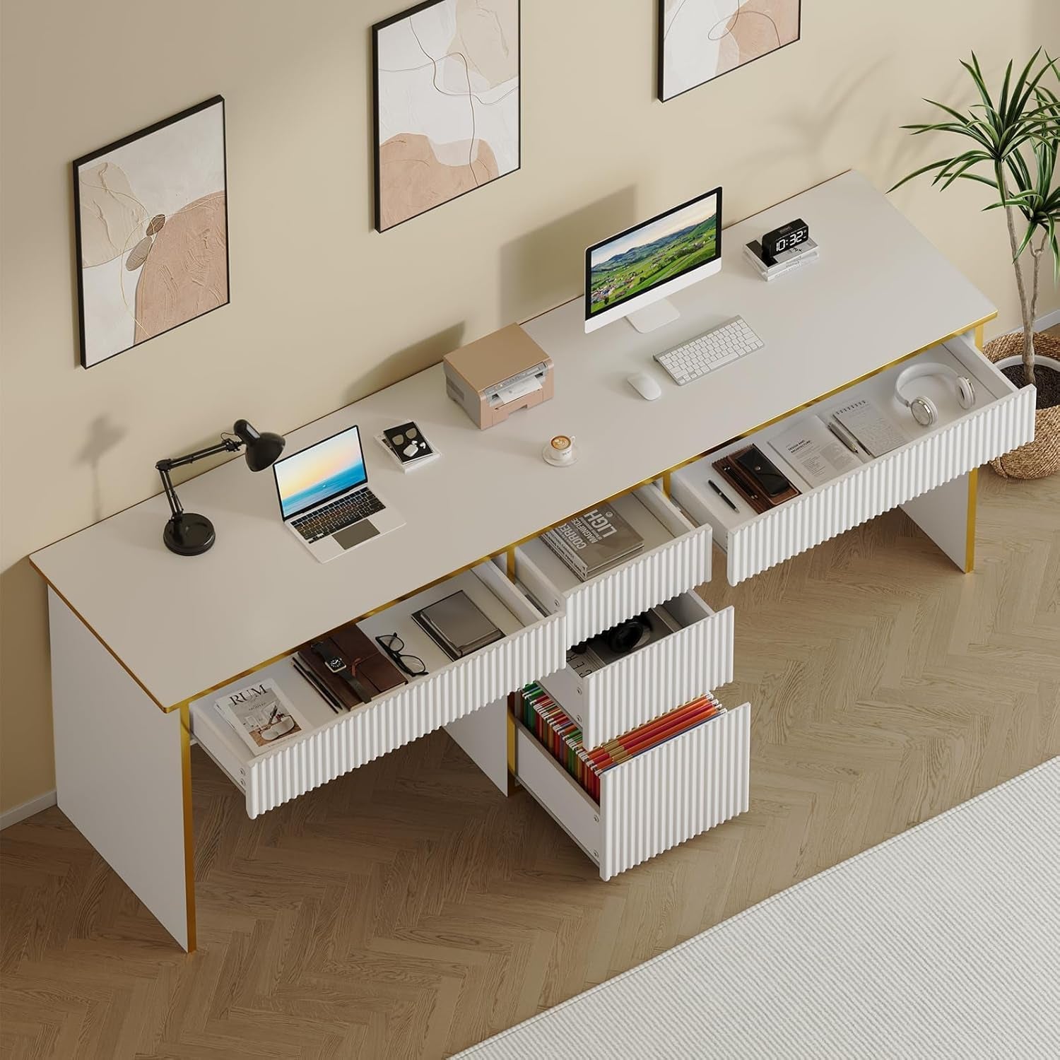 Overhead view of white engineered wood double desk with gold trim showing open drawers and workspace setup