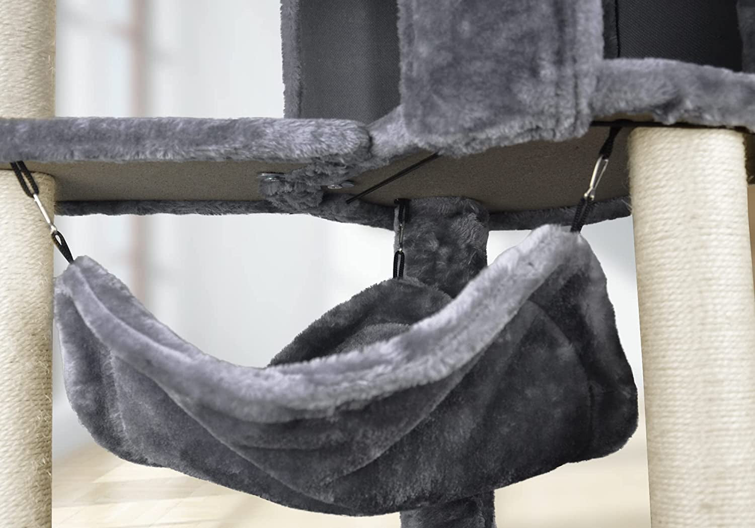 Close-up view from below of the hammock’s clipped straps and metal hooks attached to the platform.