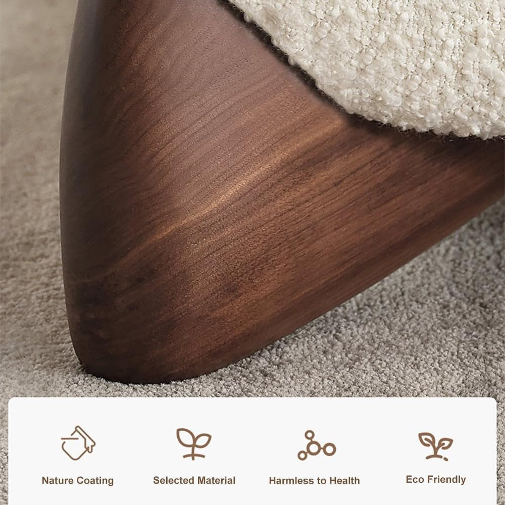 Close-up of tapered wooden foot with walnut finish under white boucle upholstery