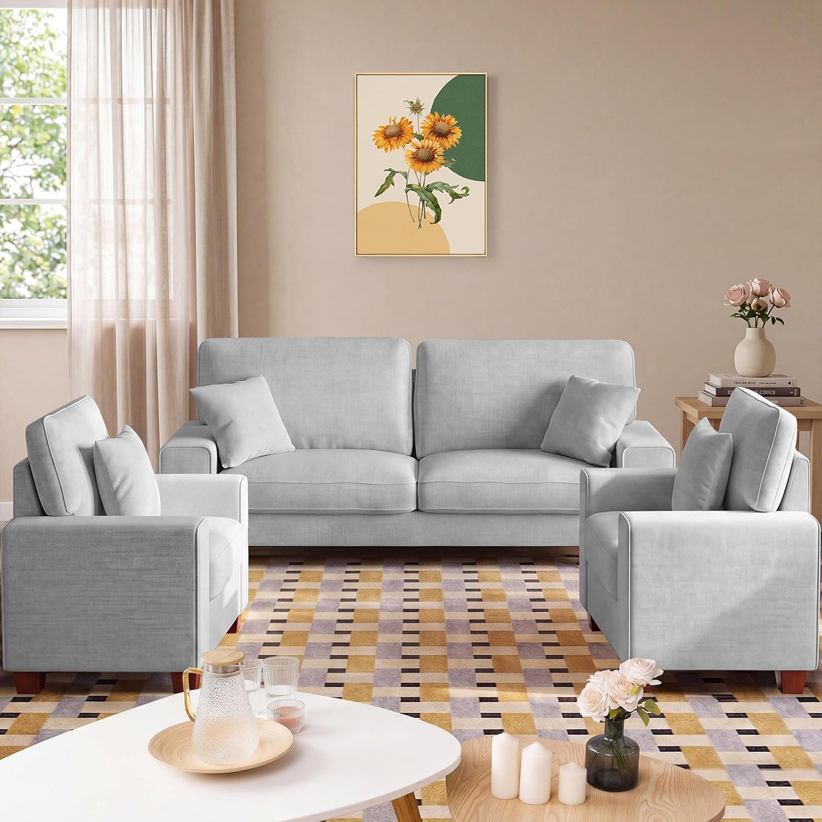 Three-piece living set: beige loveseat centered with two matching armchairs and patterned rug.