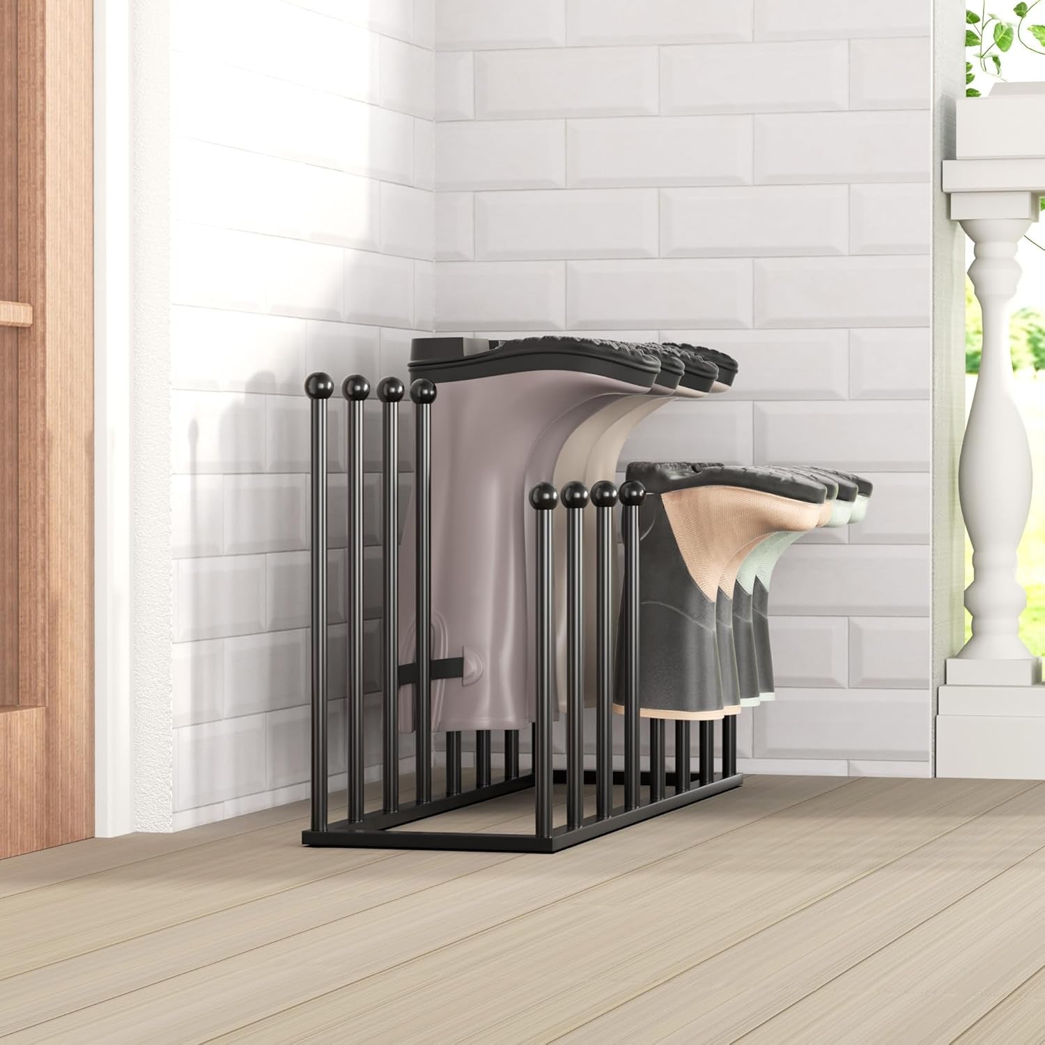 Side-angle view of the black rack against a white tiled wall showing boots stored upside-down in two rows.