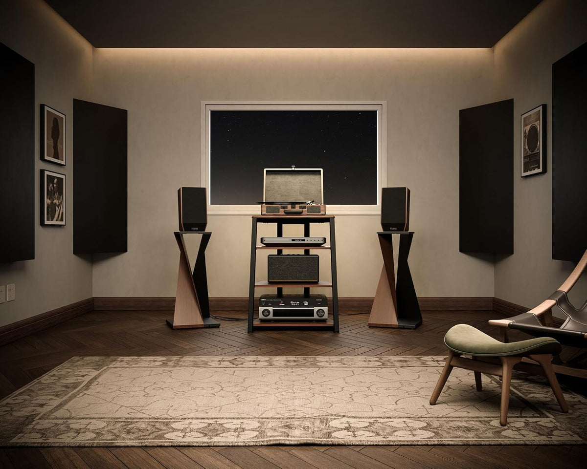 Listening-room vignette at night with single walnut stand centered between speaker pedestals beneath a dark window