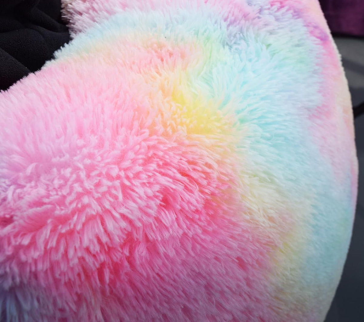 Close-up of fluffy pastel fur showing pink, blue and yellow fibers