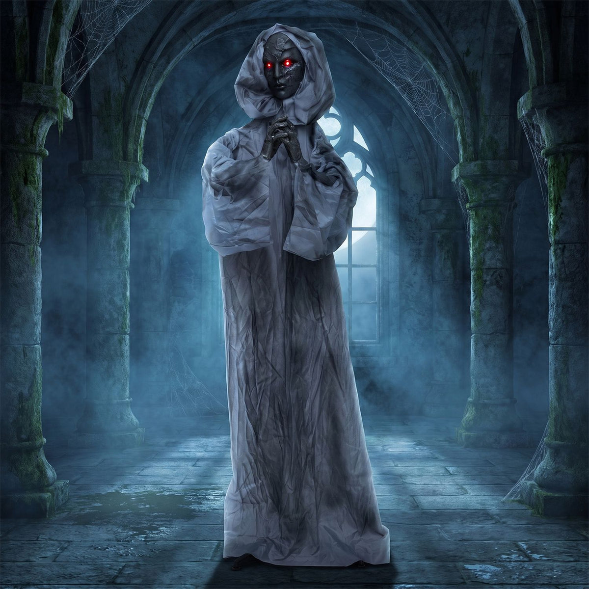 Gray-robed weeping woman animatronic posed in a dark, misty stone hall