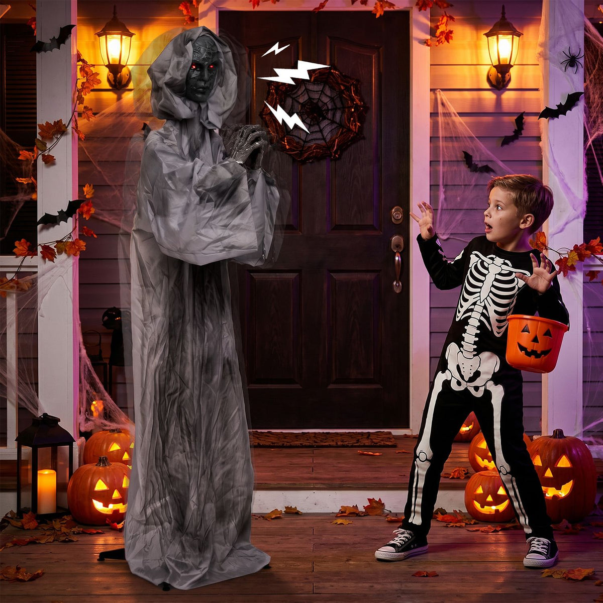 Gray-robed animatronic beside a child in a Halloween-decorated doorway