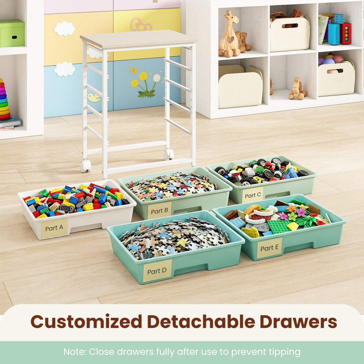 Empty rolling cart frame stands behind five removed drawers filled with colorful craft materials on the floor.