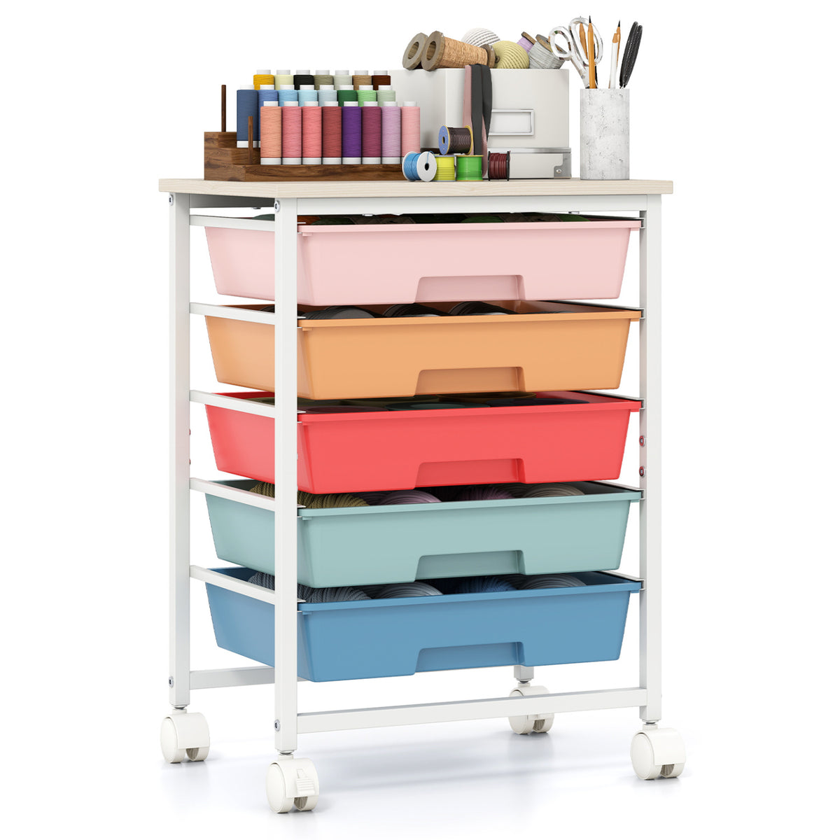 A white-framed rolling cart with five colorful bins and sewing supplies on its tabletop.