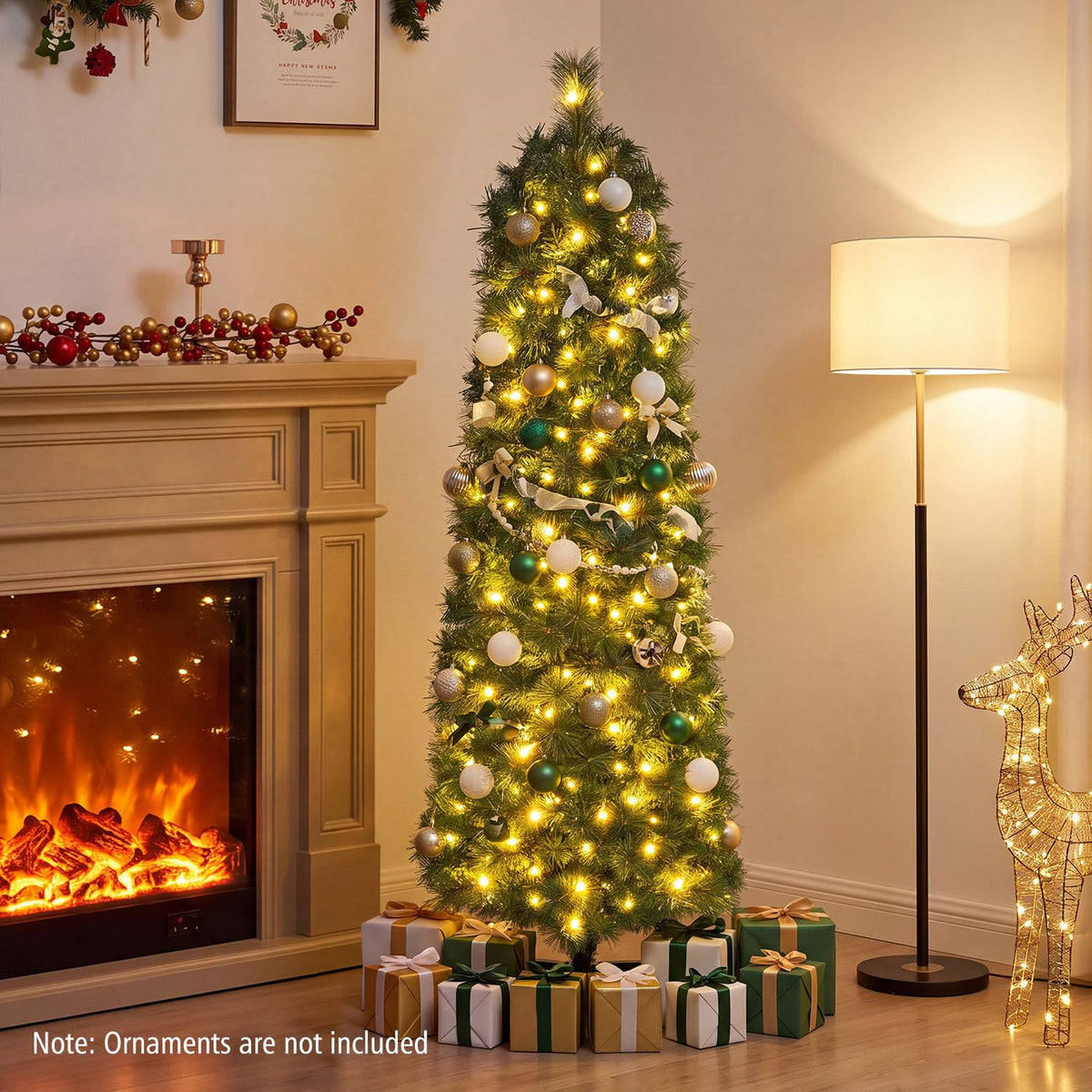 Lighted, ornamented pine tree displayed between a fireplace and floor lamp, with presents below.