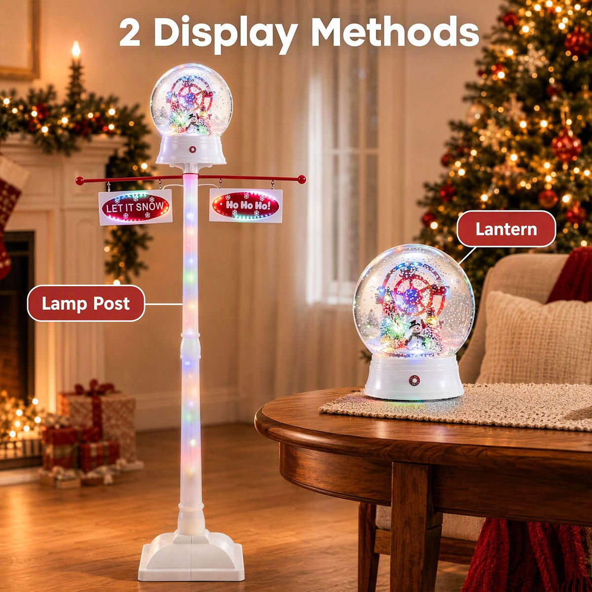 Lit white lamp post beside a separate glowing snow globe lantern on a wooden table in a festive room.