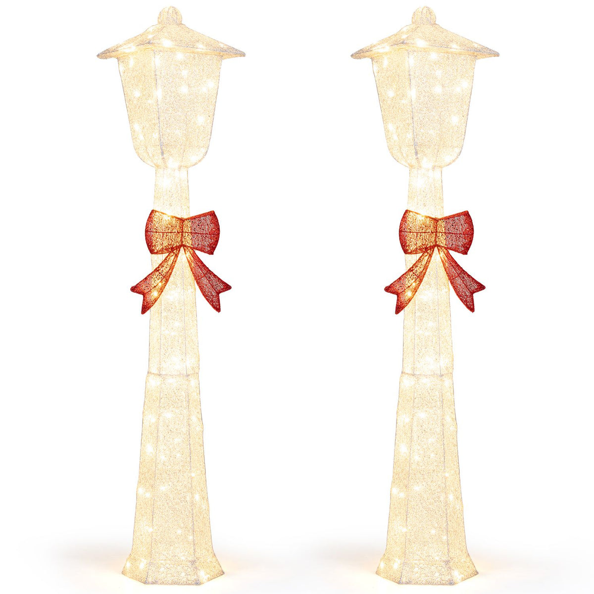 Two silver-sparkled lamp posts with red bows shown against a white background