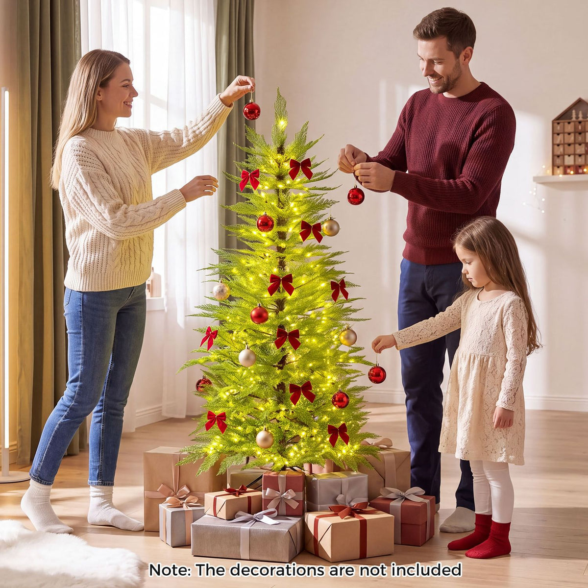 A family decorates a glowing Christmas tree surrounded by wrapped presents in a bright living room.