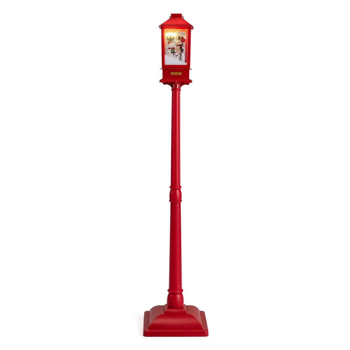 Full view of the red streetlight, with a glowing snowman scene inside its lantern.