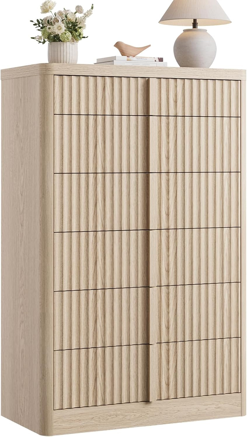 Tall light beige fluted chest with multiple vertical fluted drawer fronts shown on white background.