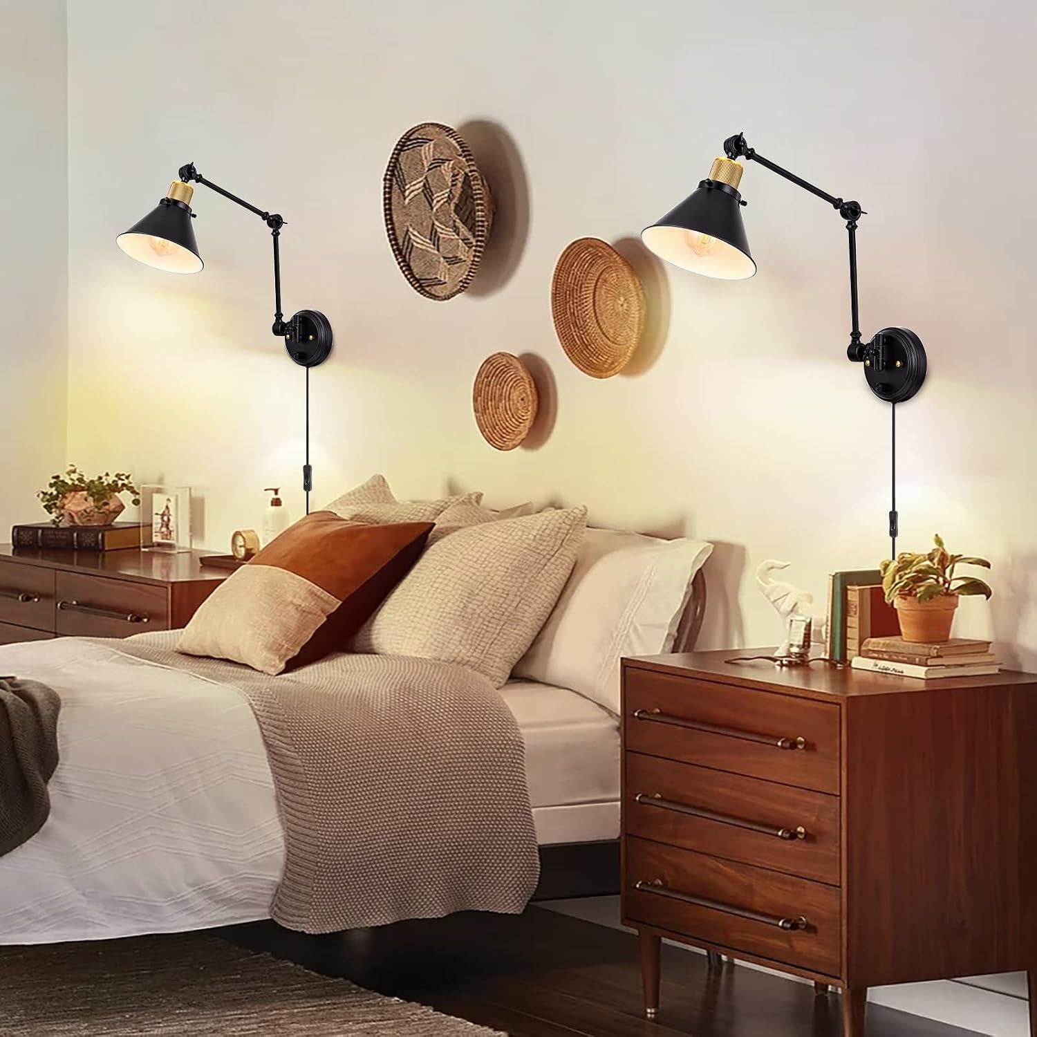 Pair of black swing‑arm wall sconces mounted above bedside tables in a cozy bedroom setting.
