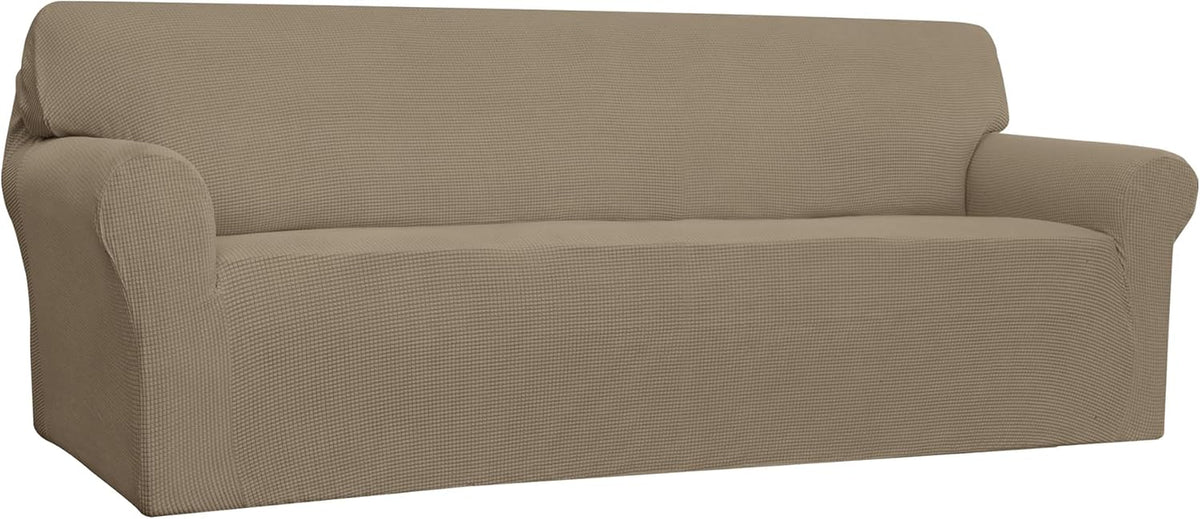 Three-quarter angled view of a two-seat loveseat in a warm khaki textured slipcover, showing arm and seat contours