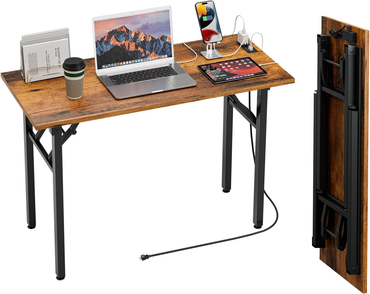 Rustic brown wood-top desk with laptop, tablet and phone charging, cup on left and folded panel shown at right.
