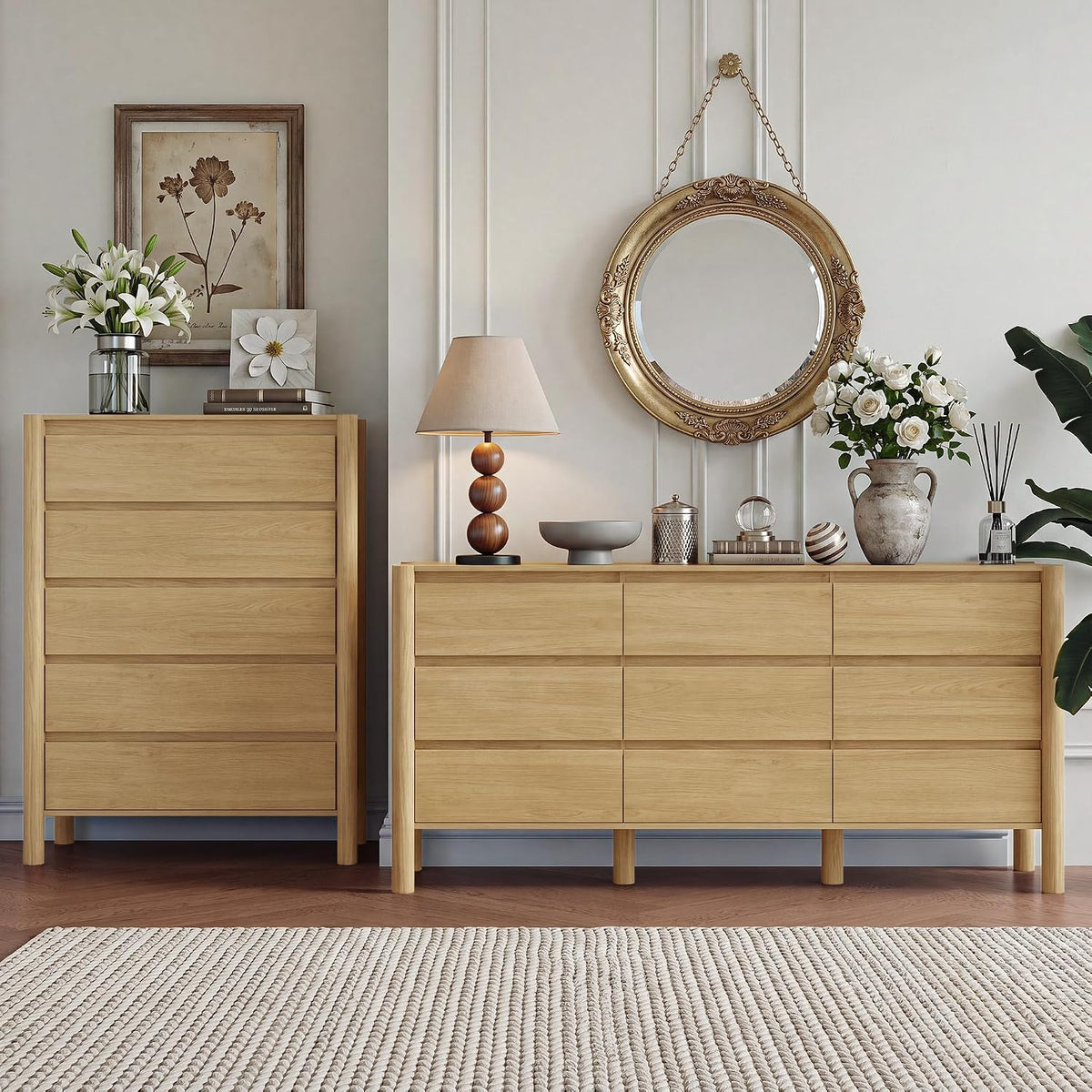 Styled dresser tops with a lamp, vase of roses and a round gilded mirror over the walnut-finish dressers.