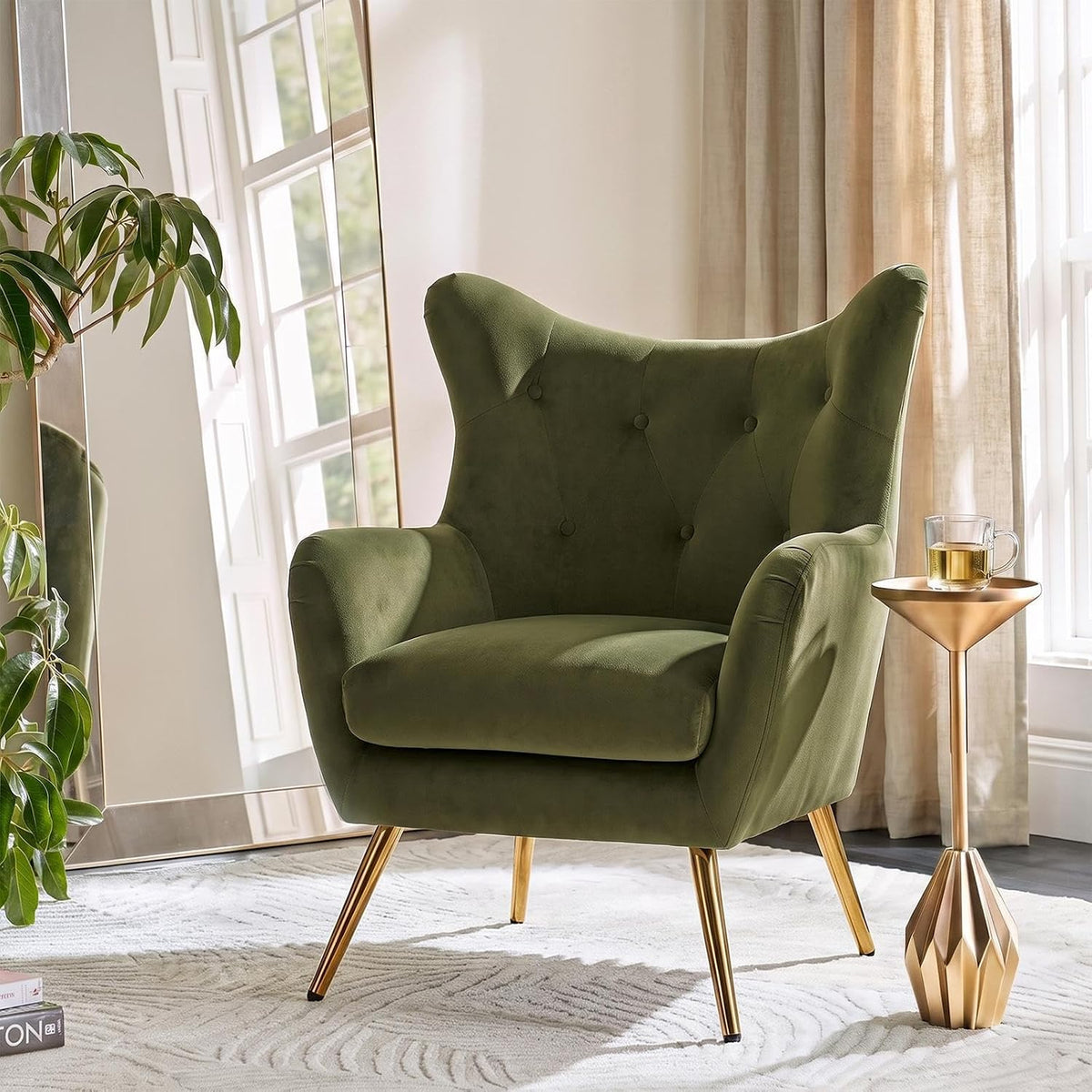 Close-up of an olive green wingback chair showing button tufting and gold-tone tapered legs