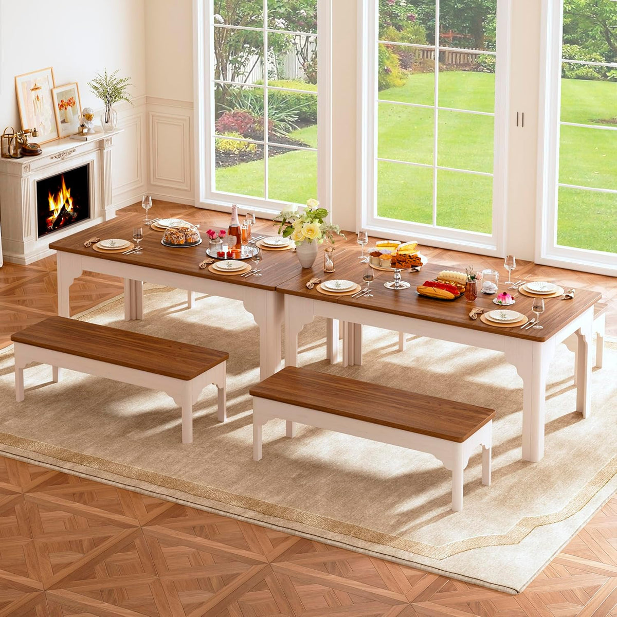 Two farmhouse tables placed end-to-end with four benches arranged for a large gathering in a sunlit room.