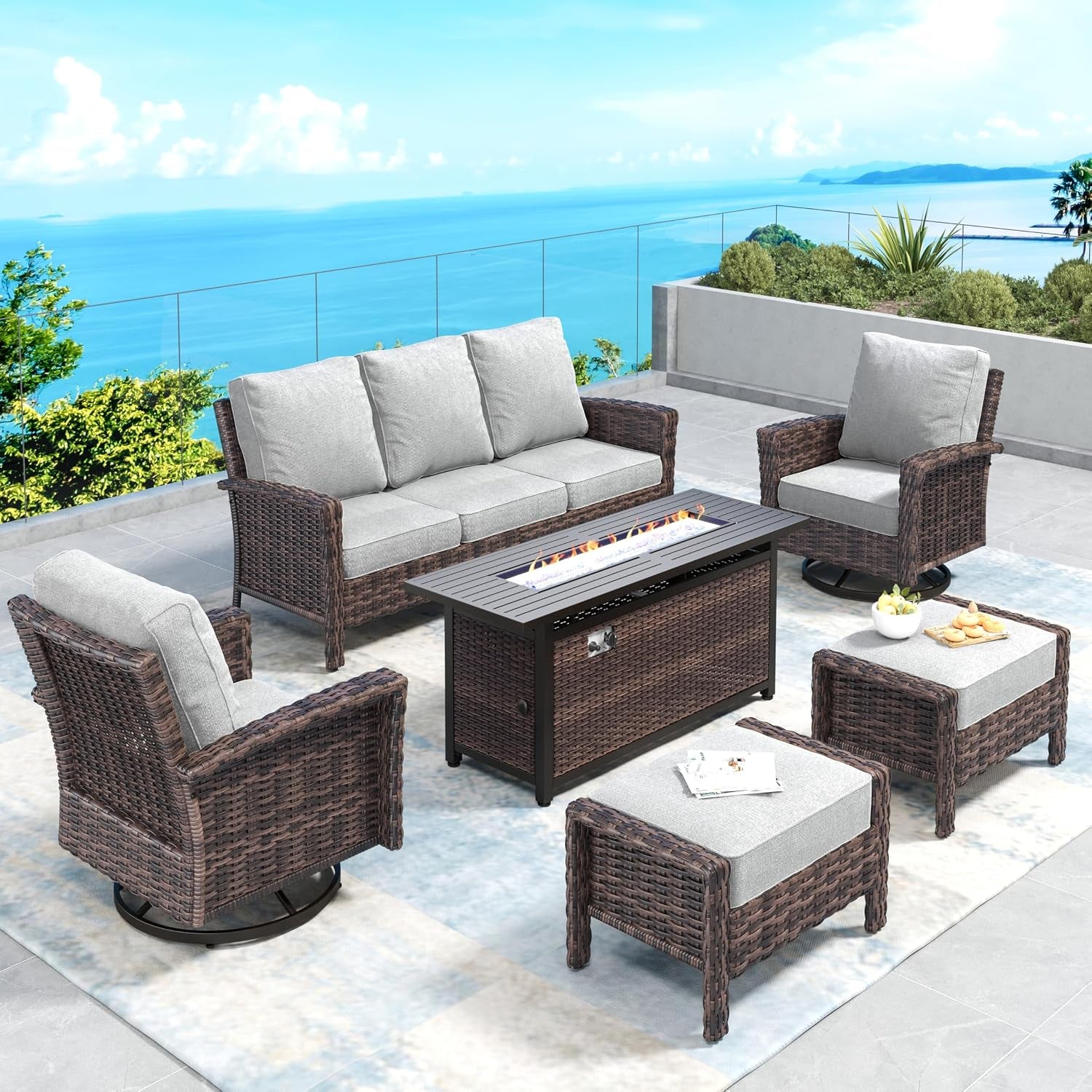Five-piece wicker seating set with three-seat sofa, two swivel chairs and two ottomans around a rectangular fire table
