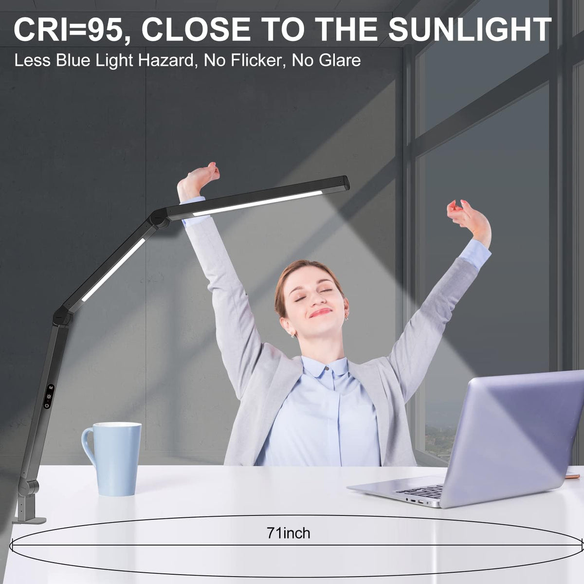 Black adjustable-arm LED lamp clamped to a white desk with a computer monitor and a person stretching in the background