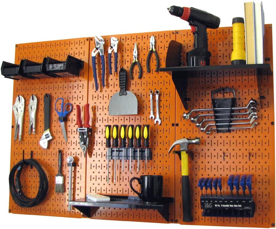 Orange metal pegboard mounted on wall with hanging hand tools, shelves, bins and a coiled cable.