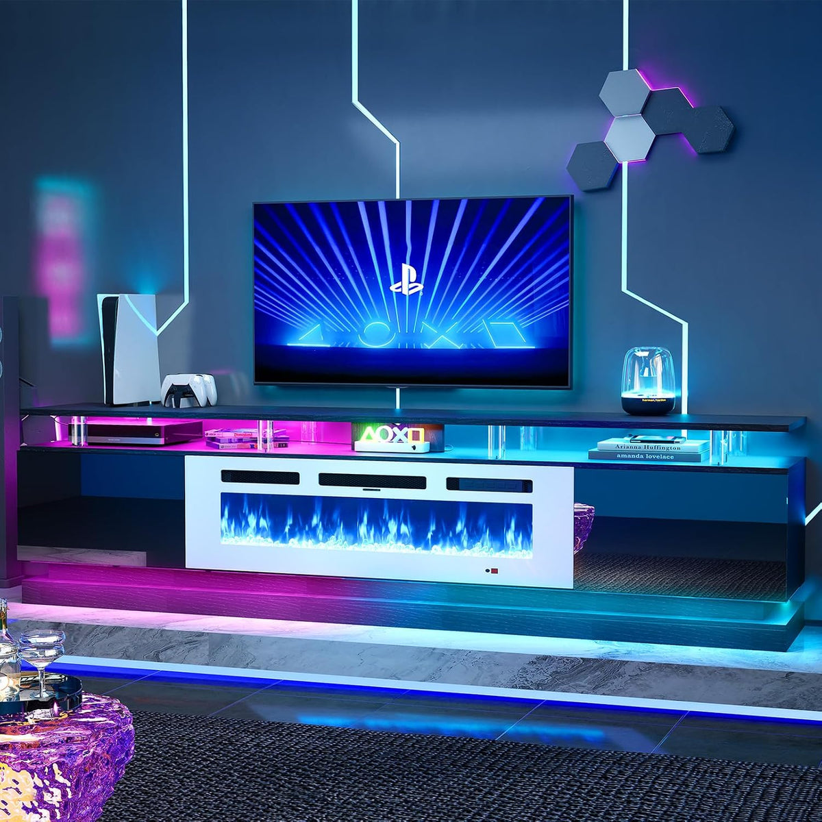 low-angle styled room view of TV stand with illuminated electric fireplace and pink and blue LED accent lights