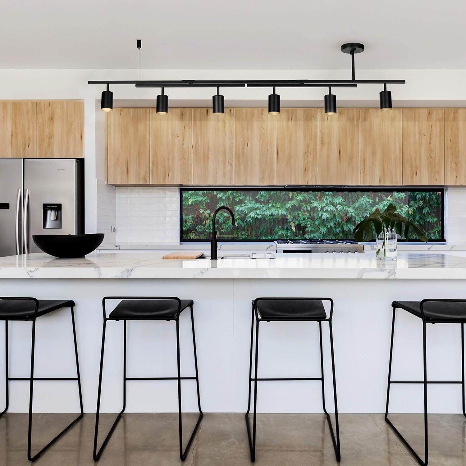Matte black 6-light track fixture installed above a kitchen island with marble countertop and bar stools