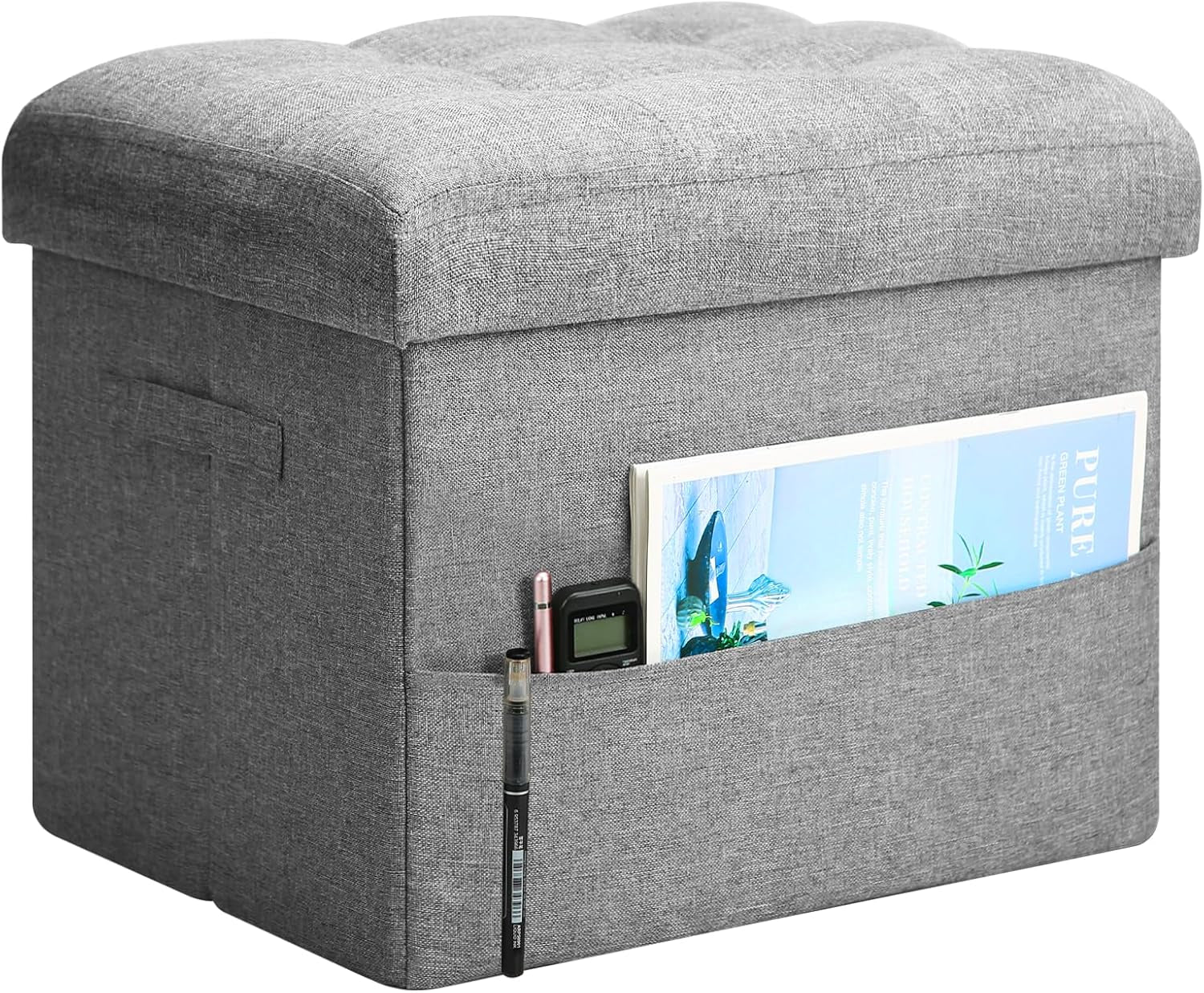 Light gray linen-look ottoman with cushioned tufted top and side pocket holding a magazine and pens