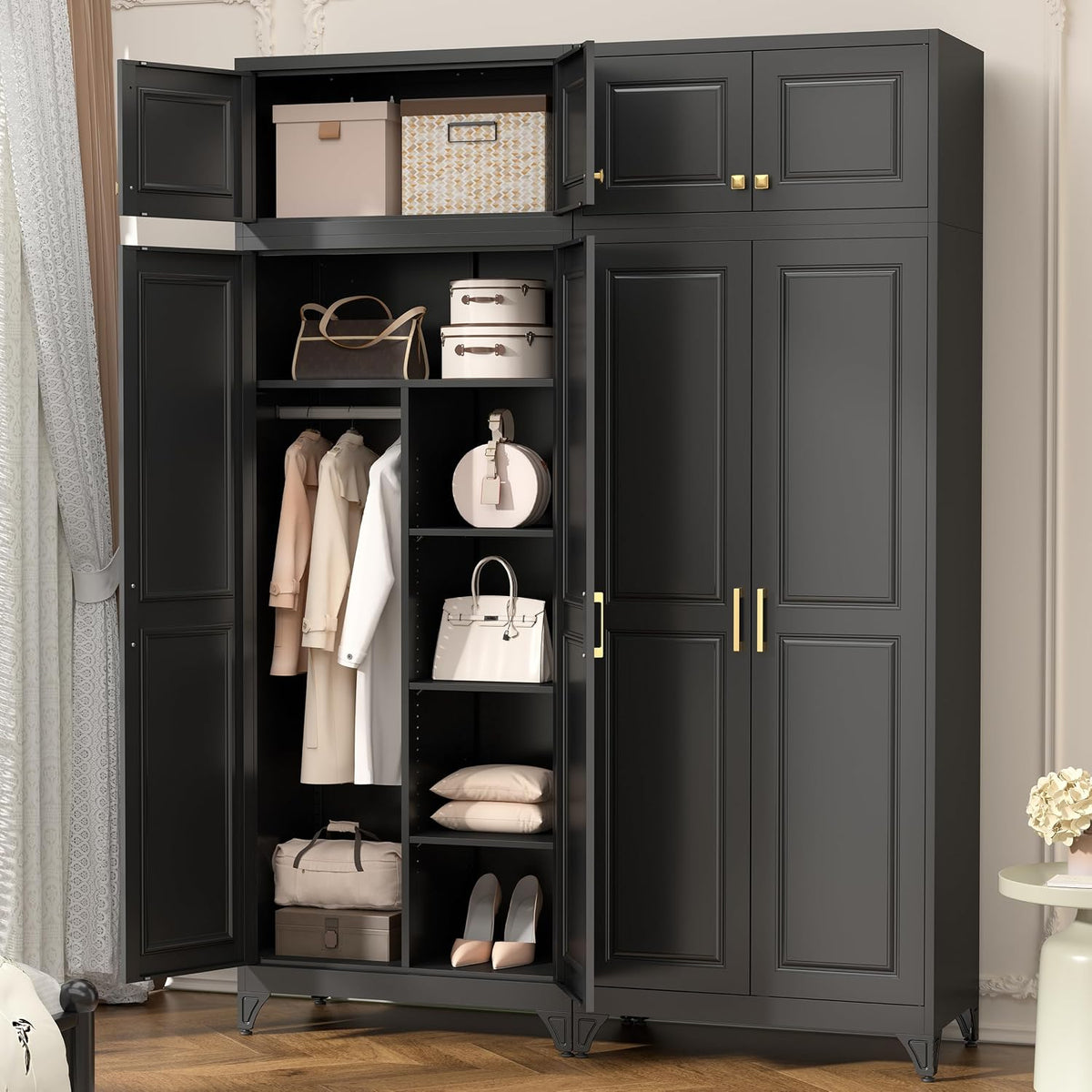 Tall black metal wardrobe with open left doors showing shelves, hanging clothes and gold handles in a bedroom.
