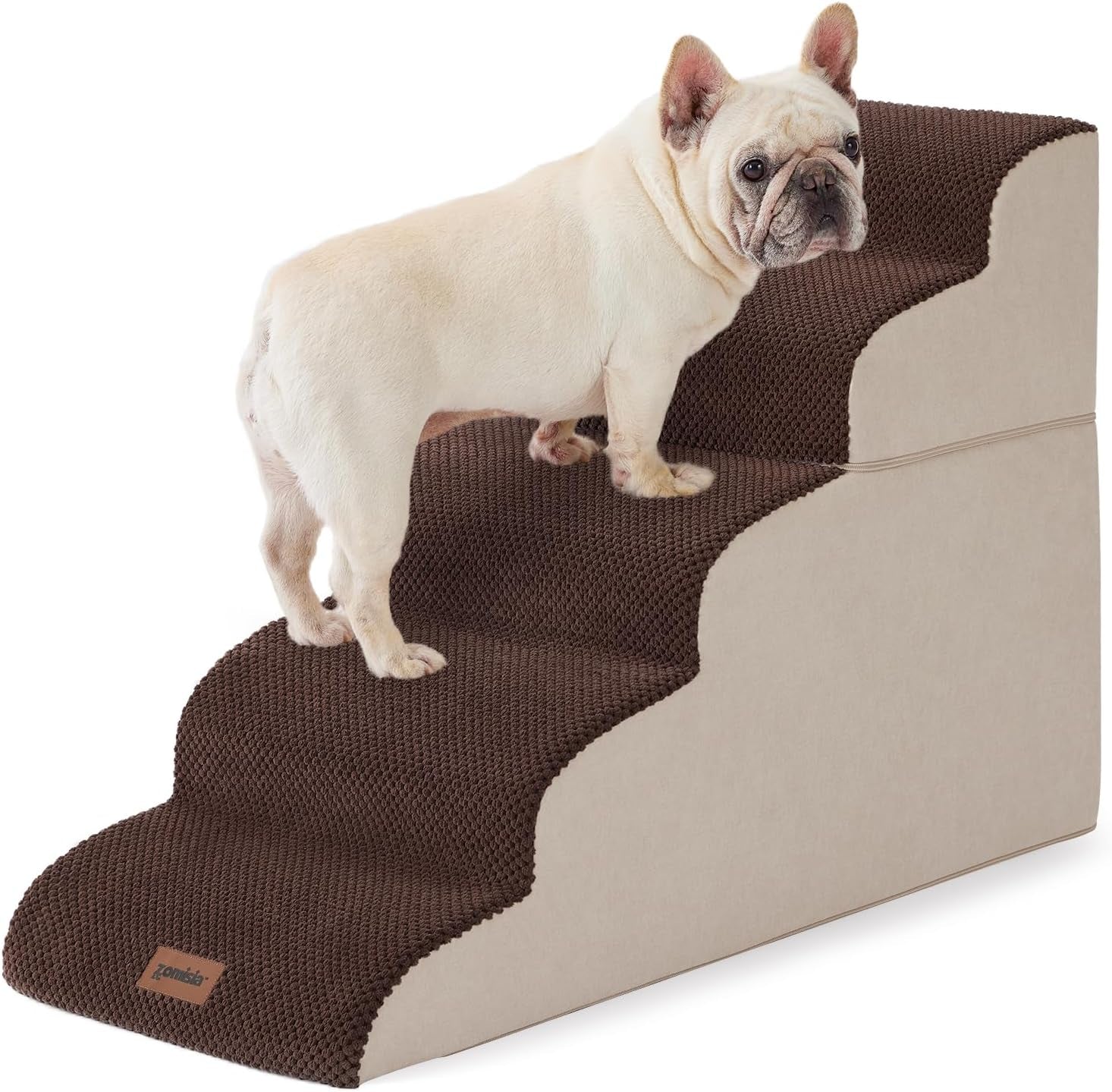 Small cream-colored dog standing on brown-covered three-step foam stairs against white background
