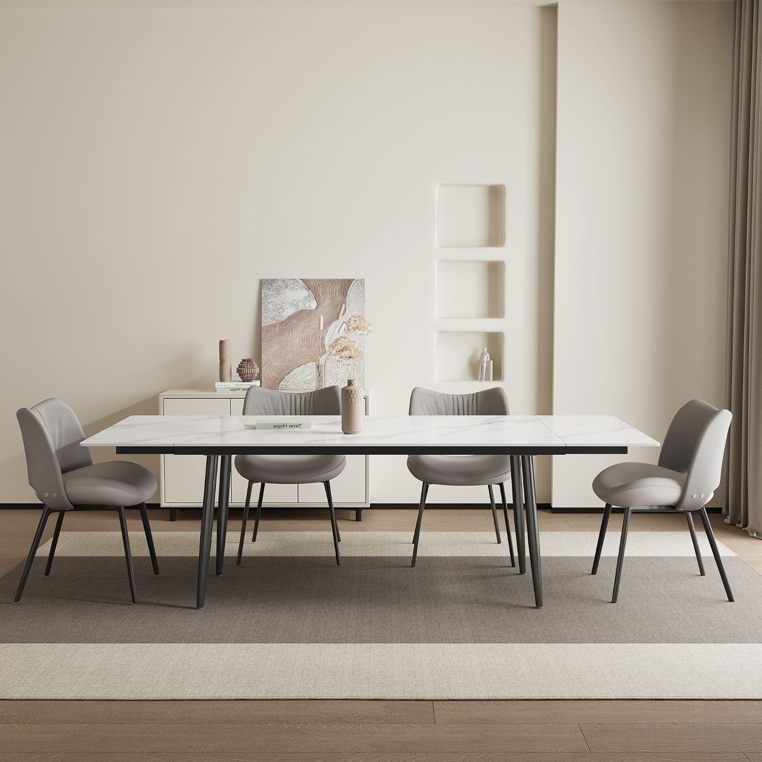 Front angled dining scene showing the extended white tabletop with chairs in a neutral room