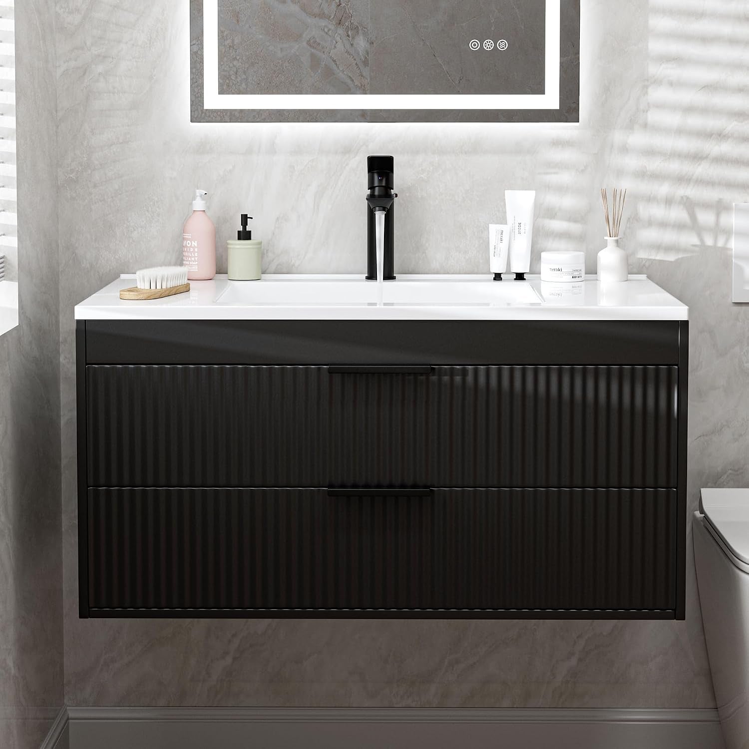 Front view of a floating black bathroom vanity with white rectangular sink and two closed ribbed drawers.