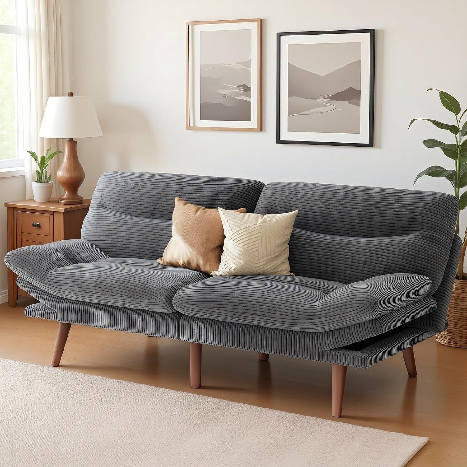 Grey corduroy futon sofa angled front view with wooden legs in a living room setting