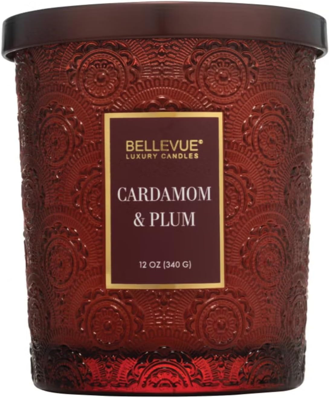 Close front view of red embossed glass candle jar with Cardamom & Plum scent label