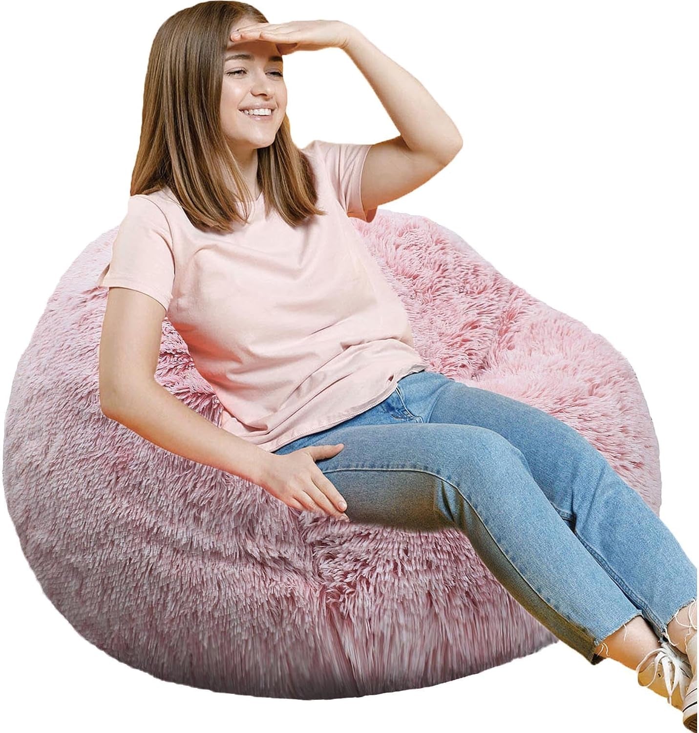 Teenage girl reclining and shading her eyes while lounging in a pink fluffy round bean bag.