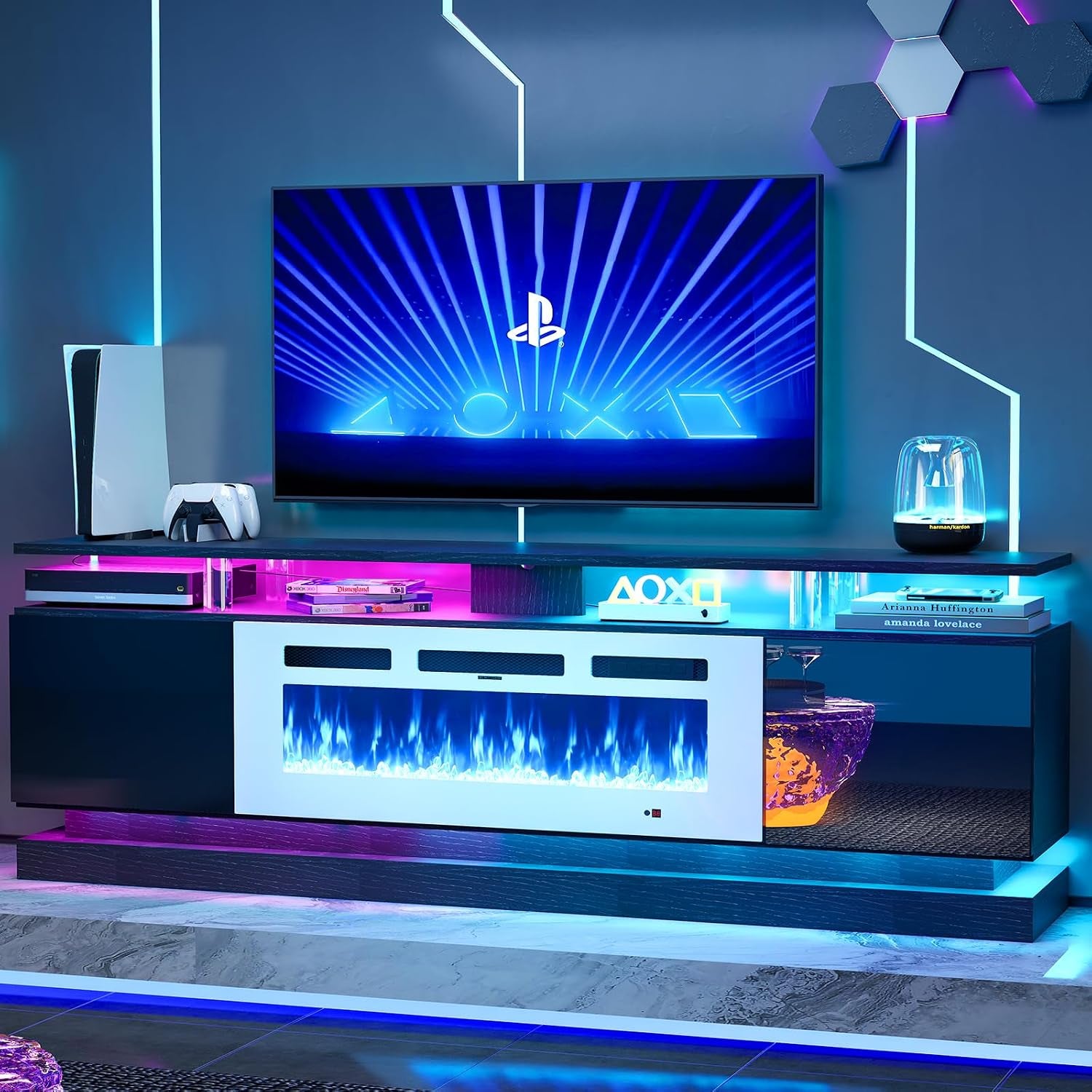 Front-facing TV console in a dark finish showing a white fireplace insert and multicolored LED shelf lighting under a wall