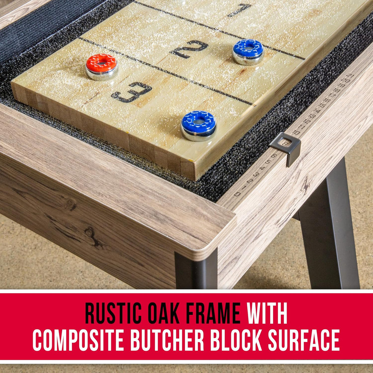 Close-up of the composite butcher block playing surface with red and blue metal pucks and sand-like wax residue near the rail