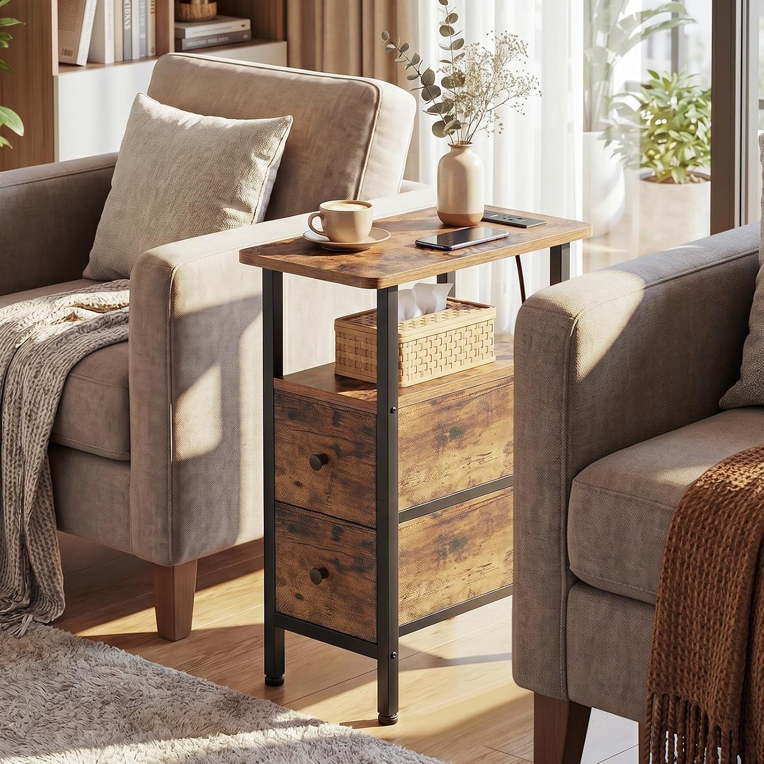 Single narrow side table between two upholstered chairs holding a cup, phone and small vase.