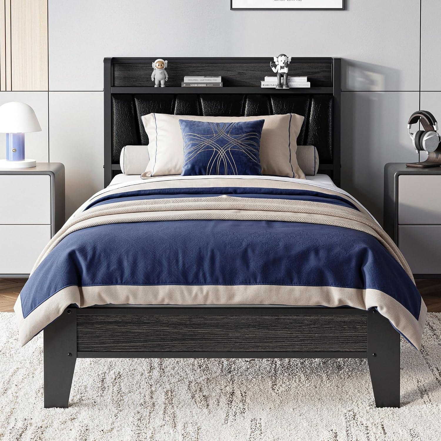 Front view of dark wood bed with black tufted headboard, navy-and-beige bedding and bedside tables.