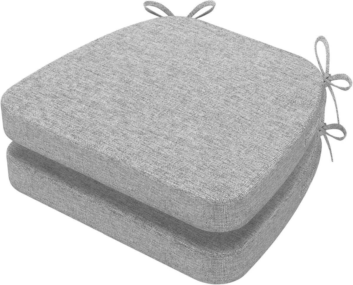 Two stacked light heather gray D-shaped chair cushions with corner ties visible