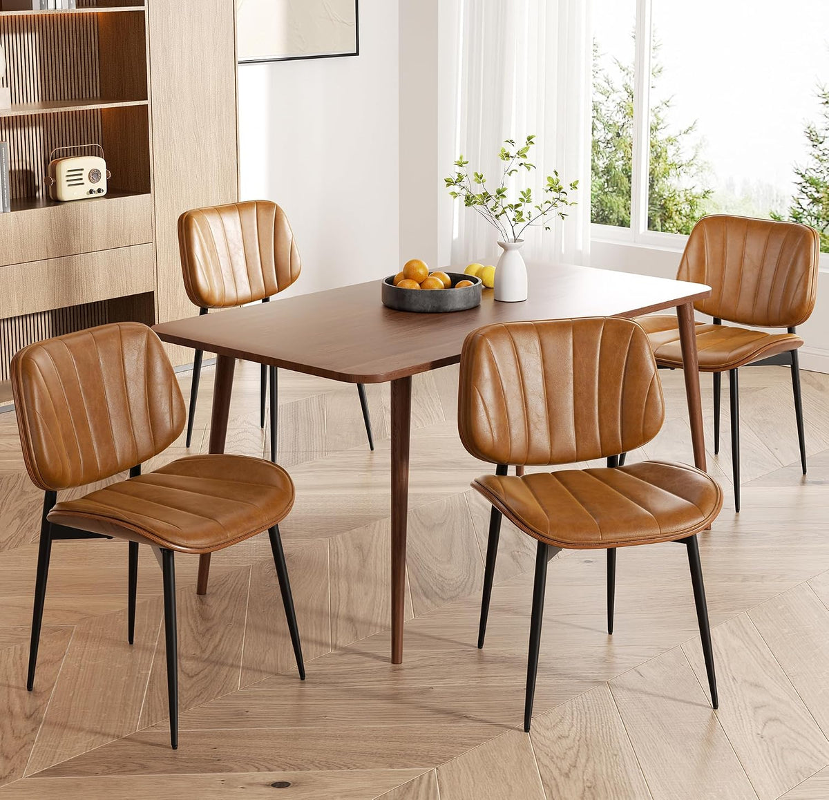 Close side view of tan faux-leather chairs with stitched vertical channels and walnut curved backs.