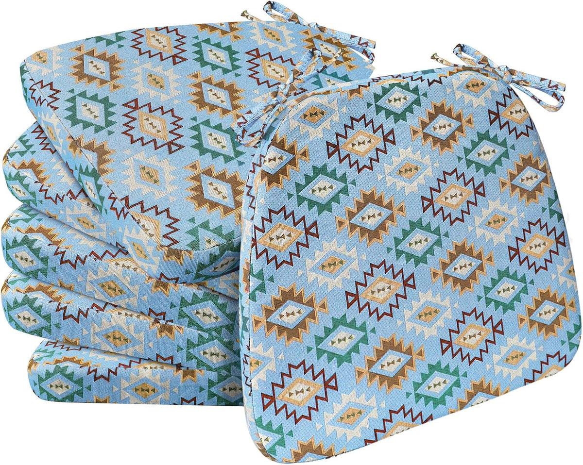 Set of D‑shaped chair pads in a blue geometric southwestern pattern stacked with one propped forward