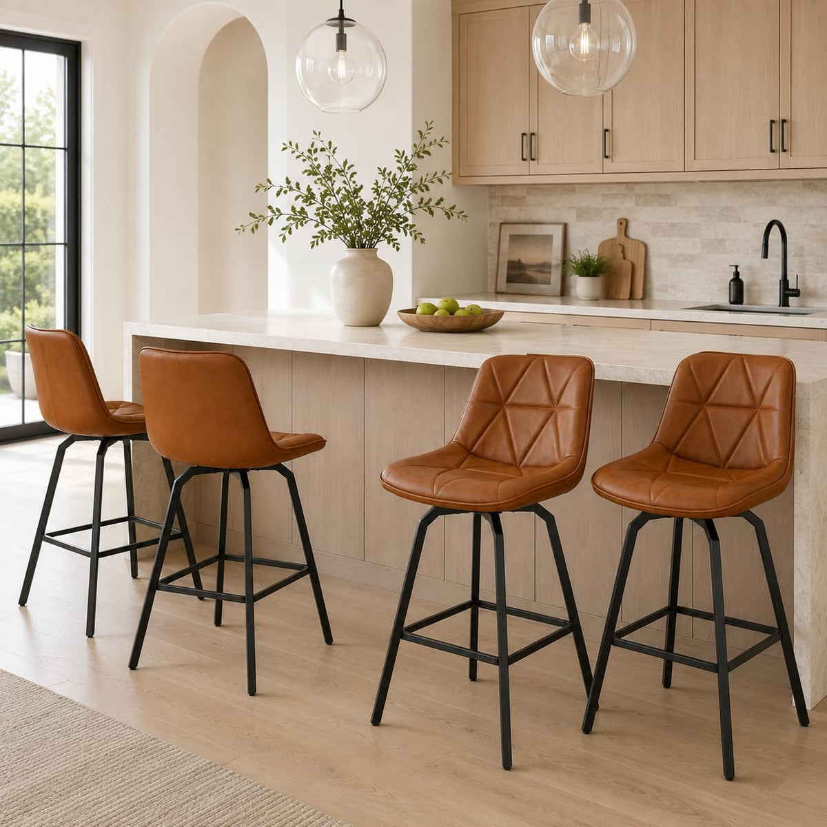 Four cognac brown faux‑leather counter stools with stitched triangular pattern at an island