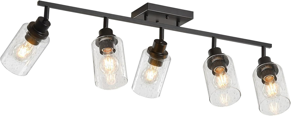 Matte black five-light track fixture with seeded glass shades, angled front view