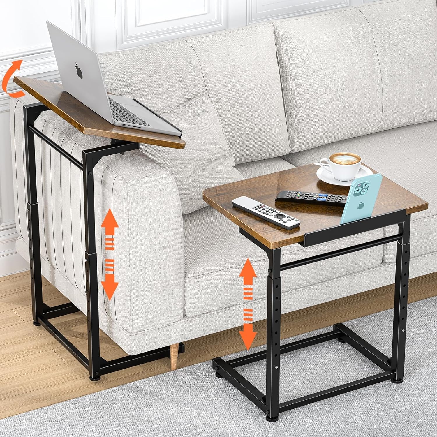 Two brown wood-top C-shaped side tables next to a light gray sofa, one tilted with a laptop, one flat with remotes and phone.