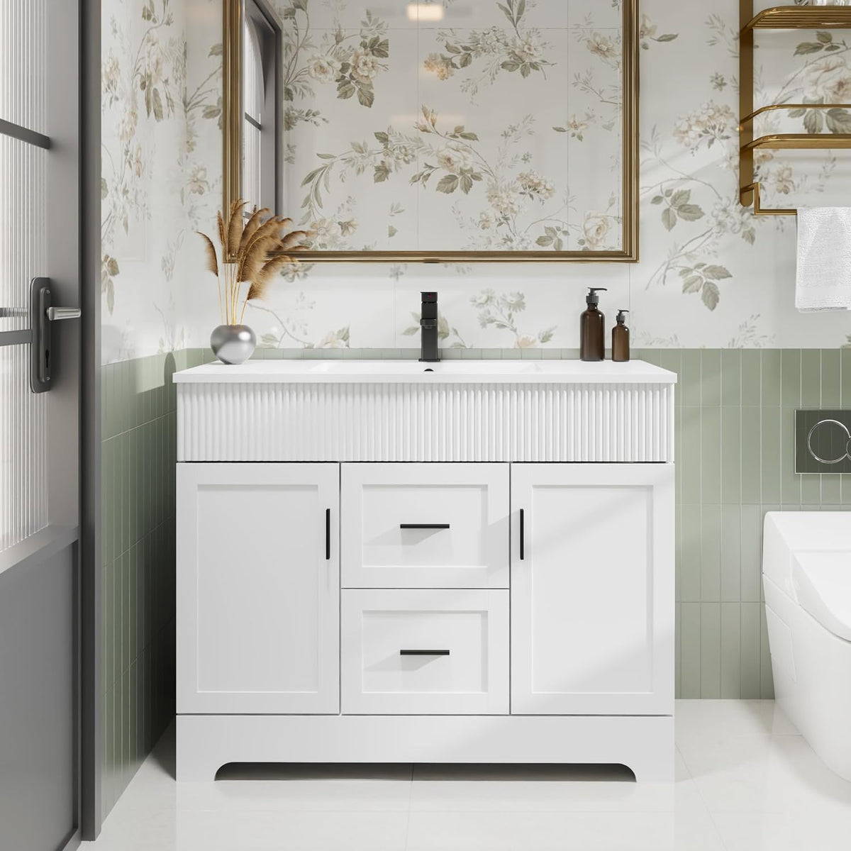 Front view of a white single-sink vanity with fluted wave front, black faucet and floral mirror above.