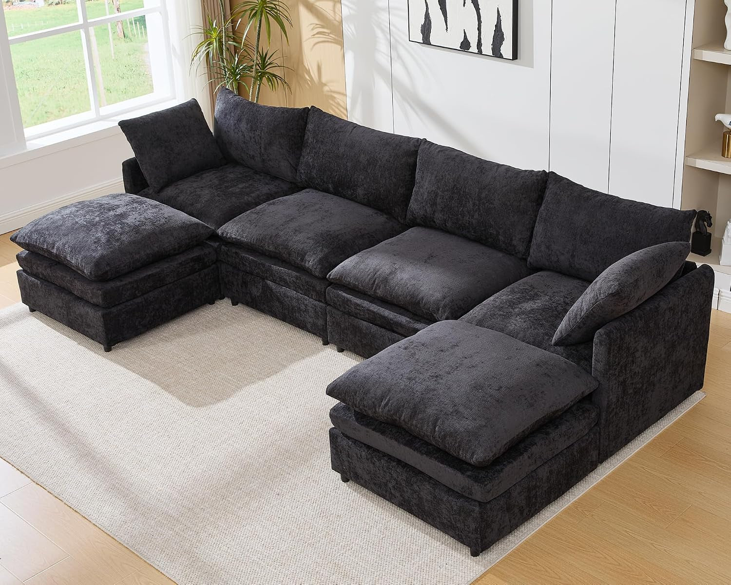 Dark gray four-seat U-shaped sectional with an ottoman at each end.