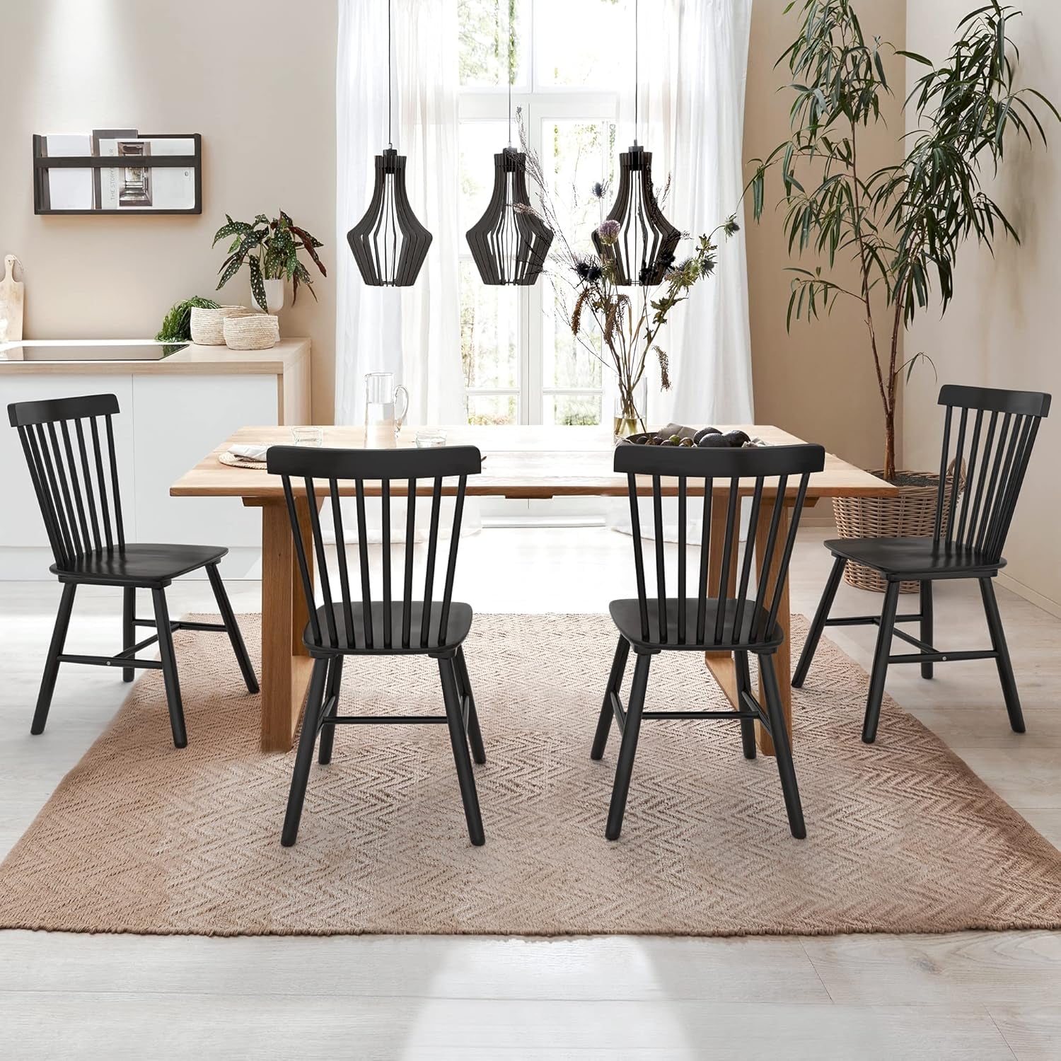Black Windsor spindle-back dining chairs around a wooden table in a bright dining room, front view.