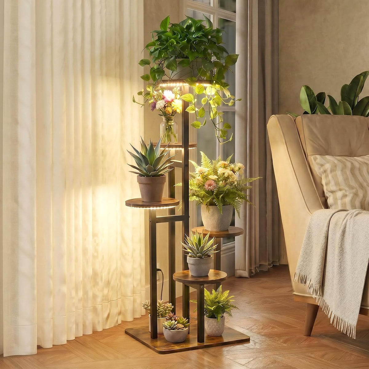 Tall tiered stand with staggered round wooden shelves holding succulents and a trailing pothos beside a beige armchair